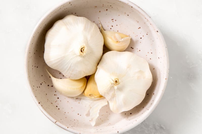 garlic in a small bowl on a marble surface