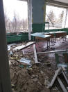 This April 26, 2022 photo provided by Ukrainian school administrator Valentina Grusha shows damage to the Cooks Comprehensive school complex in Kukhari, Ukraine. The village outside Kyiv was under Russian occupation in March and April, until Ukrainian forces drove them out. (Valentina Grusha via AP)