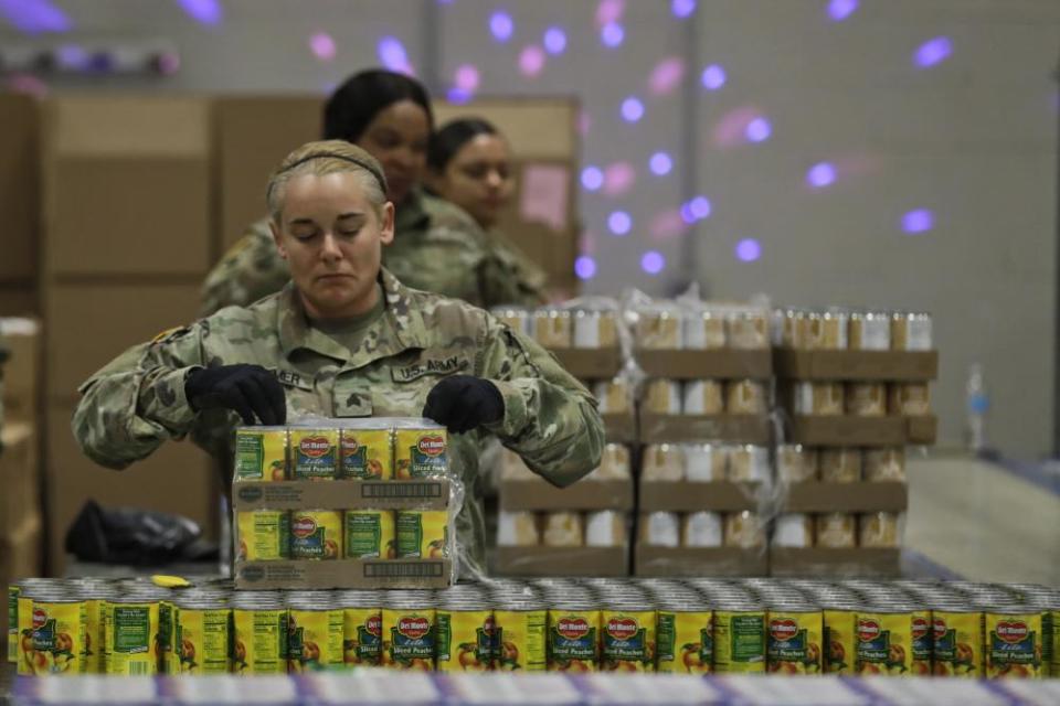 Ohio National Gaurd Sgt. Kelley Kremer assists in repackaging emergency food boxes for food distribution at the Cleveland Food Bank, Tuesday, March 24, 2020, in Cleveland. State parks have shuttered cabins, golf courses and marinas as Ohio enters its first full day of a statewide “stay at home” order to slow the spread of the coronavirus. Grocery stores, gas stations and other essential businesses remain open.