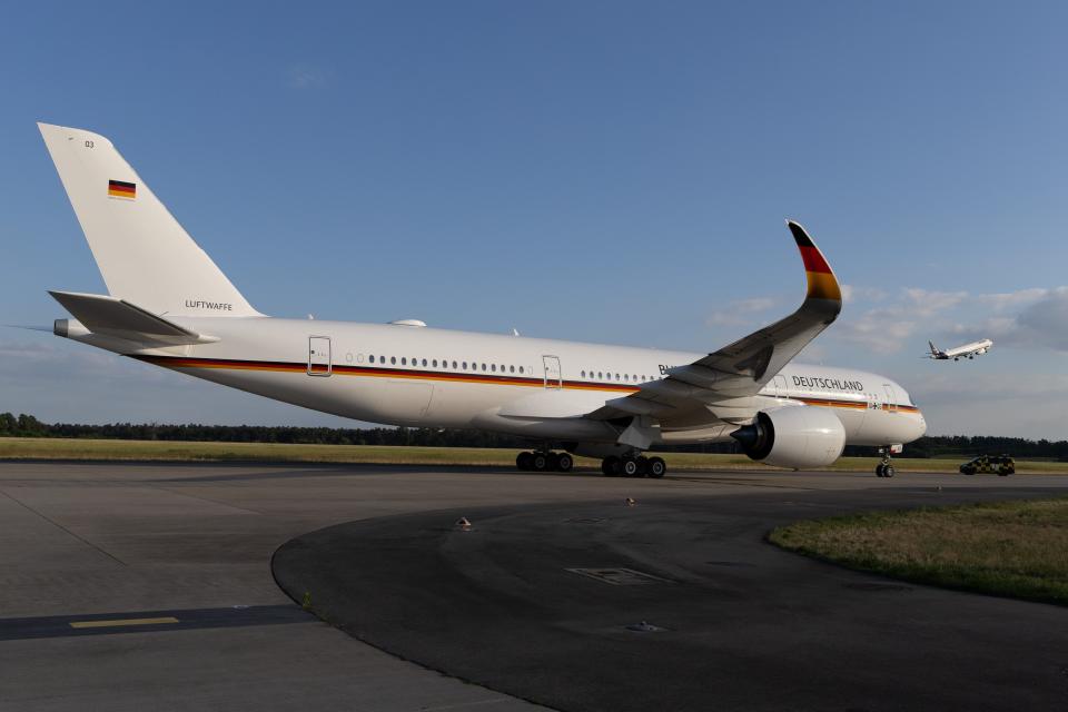 The A350 with black, red, and gold on wingtip.