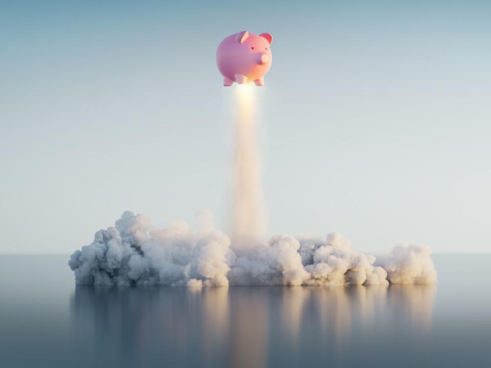 A piggy bank launching like a rocket.