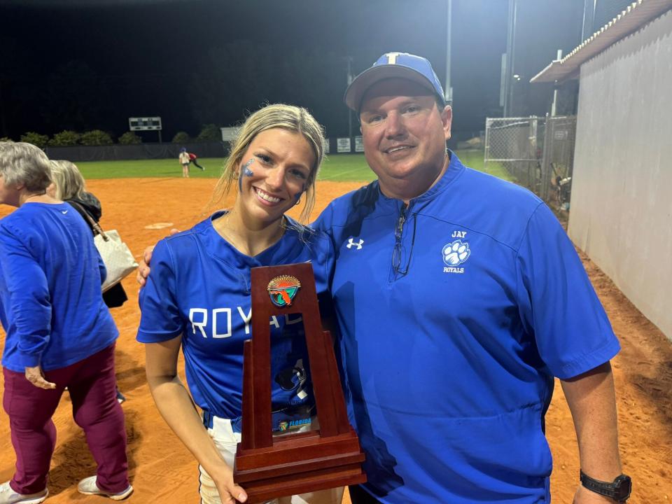 Jay softball senior Brett Watson (left) and her father, who is also the Royals' head coach, Brian Watson, celebrate their fourth consecutive district championship together on Thursday, May 2, 2024, at Central High School.