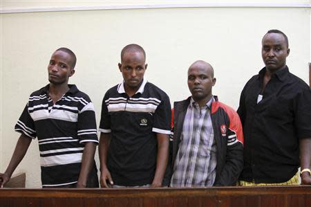 Somali pirates stand at the dock during their sentencing at a court in the Kenyan coastal town of Mombasa October 23, 2013. REUTERS/Joseoph Okanga