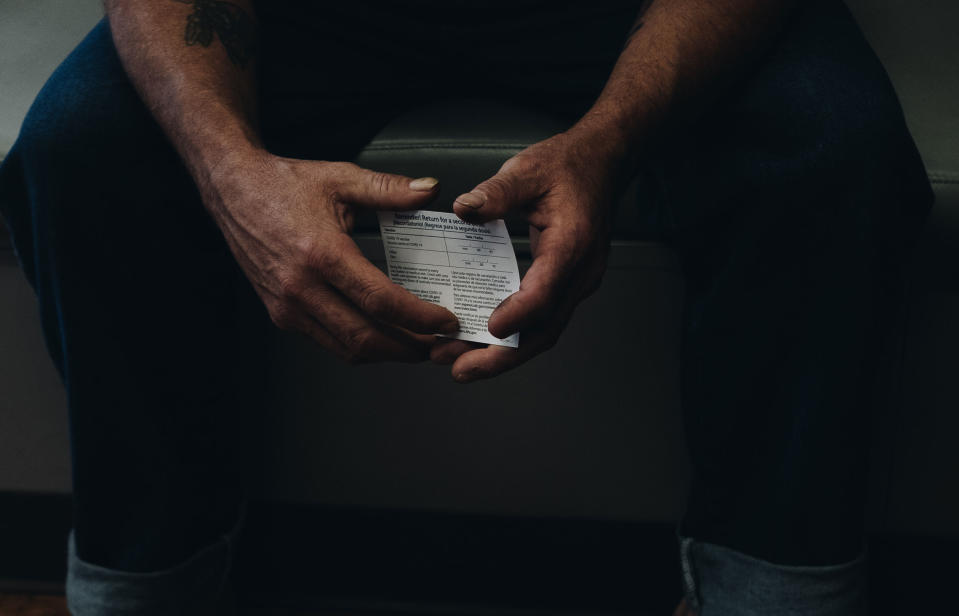 James Hunt holds his vaccination card<span class="copyright">Khadija Farah for TIME</span>