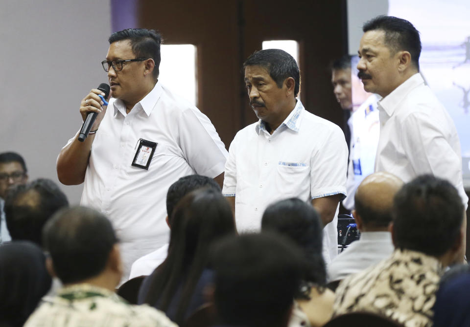 Director of Safety and Security of Lion Air, Daniel Putut Kuncoro Adi, left, talks to relatives of the victims of the crashed Lion Air jet as President Director Edward Sirait, center, and founder and owner of the airline Rusdi Kirana, right, listen during a press conference in Jakarta, Indonesia, Monday, Nov. 5, 2018. Distraught and angry relatives of those killed when a Lion Air jet crashed last week have confronted the airline's executives during a meeting arranged by Indonesian officials. (AP Photo/Achmad Ibrahim)