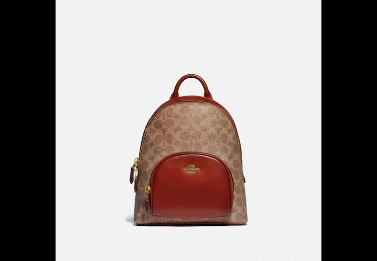 Carrie Backpack 23 In Signature Canvas. Image via Coach.