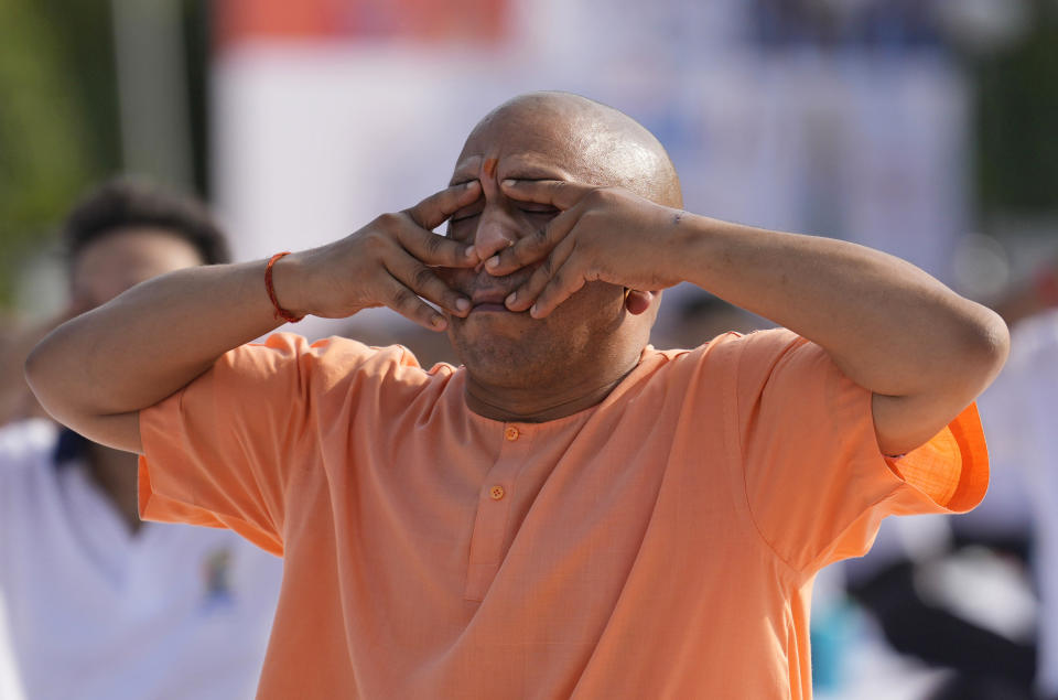 Chief Minister of Uttar Pradesh Yogi Adityanath performs yoga along with others to mark the International Day of Yoga in Lucknow, India, on June 21, 2022.<span class="copyright">Rajesh Kumar Singh—AP</span>