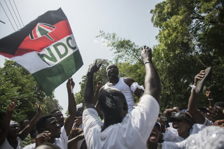 Supporters of Ghana's National Democratic Party (NDC) cheer as they wait for results of the general elections, outside incumbent President John Mahama's house in the Accra district of Labone, on December 9, 2016