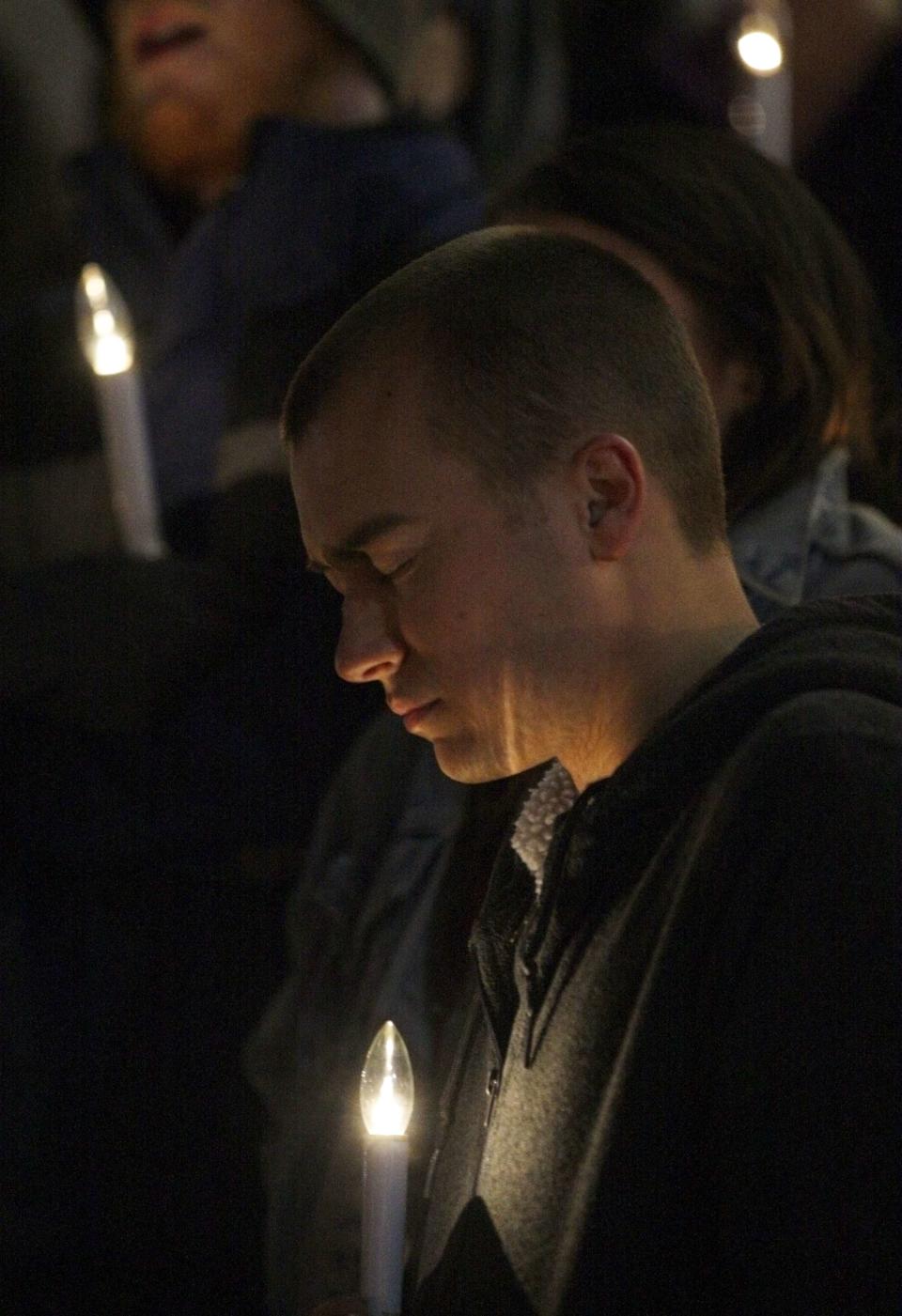 Adam Dirnberger prays while attending a candlelight vigil for death row inmate Joseph Franklin on the steps of St. Francis Xavier Church in St. Louis