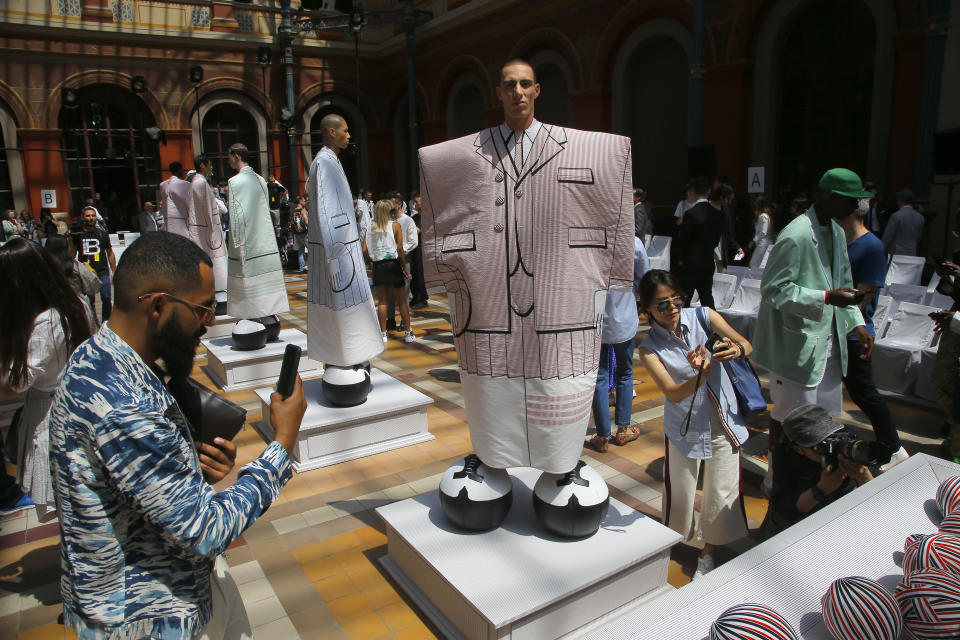 Guests take pictures of model at the Thom Browne mens Spring-Summer 2020 fashion collection presented in Paris, Saturday, June 22 2019. (AP Photo/Michel Euler)