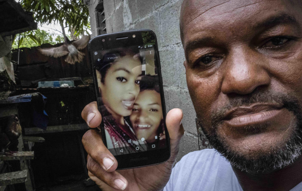 Emilio Roman shows a photo of his 26-year-old son Yosney, a construction worker, and 24-year-old daughter Mackyanis, a housewife, who were sentenced to 10 years on sedition charges for taking part in the July 2021 protests, in his home in the La Guinera neighborhood of Havana, Cuba, Friday, July 1, 2022. "They haven't committed a crime so serious that it warrants that punishment," said Roman. (AP Photo/Ramon Espinosa)