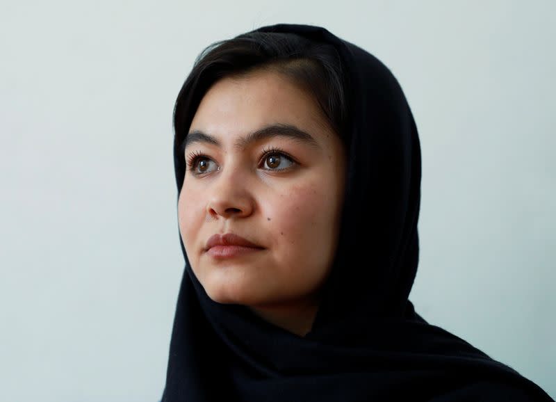 Shamsia Alizada,18, who has come top in the country's university entrance exam, speaks during an interview at her house in Kabul