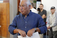 Portuguese Prime Minister and Socialist Party leader Antonio Costa picks up his ballot paper to vote at a poll station in Lisbon Sunday, Oct. 6, 2019. Portugal is holding a general election Sunday in which voters will choose members of the next Portuguese parliament. (AP Photo/Armando Franca)