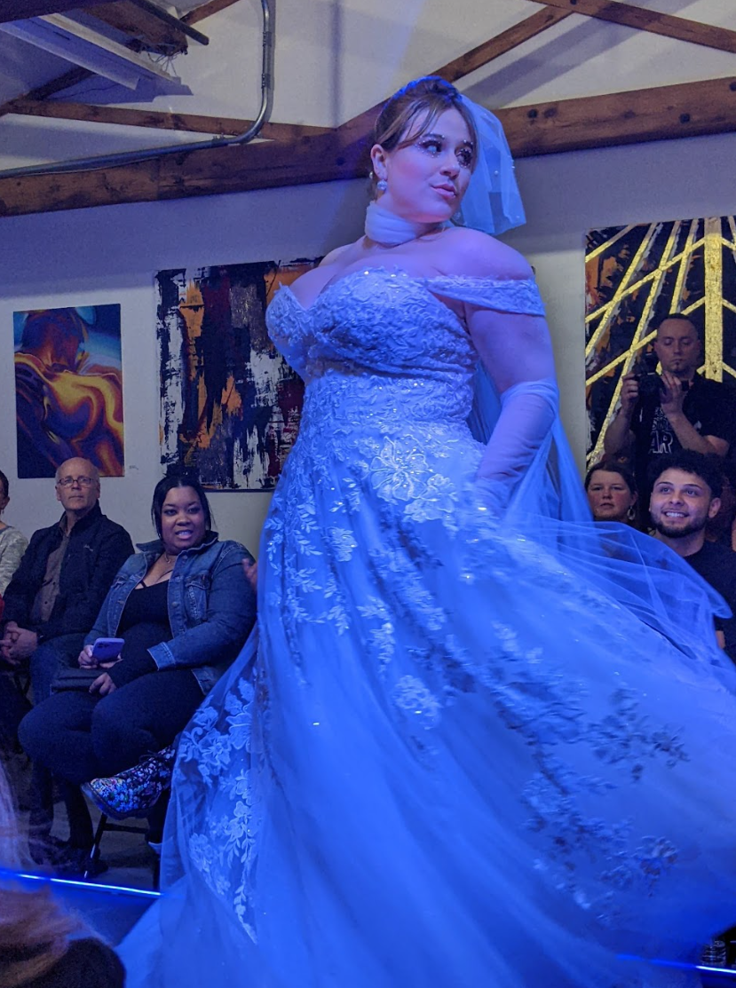 A February fashion show hosted by Positive Street Art gave designers of varying experience levels a place to debut their lines of clothing, like this wedding gown by Vieira Luxe. Cecelia Ulibarri, who leads Positive Street Art, said their mission is to hold space for all creatives at the event. She said she was dismayed by the recent wave of arts closures, especially as many turned to the arts as an outlet during the pandemic.