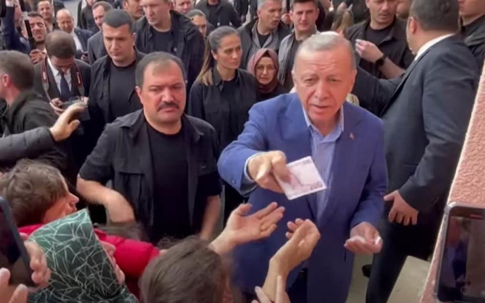 President Erdogan was videoed distributing money to his supporters - REUTERS