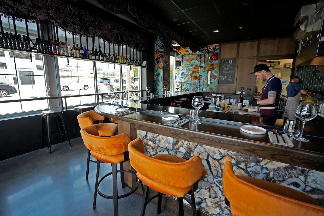 1033 Executive Chef Adam Kemmler, left, works behind the bar at the Walker's Point restaurant.