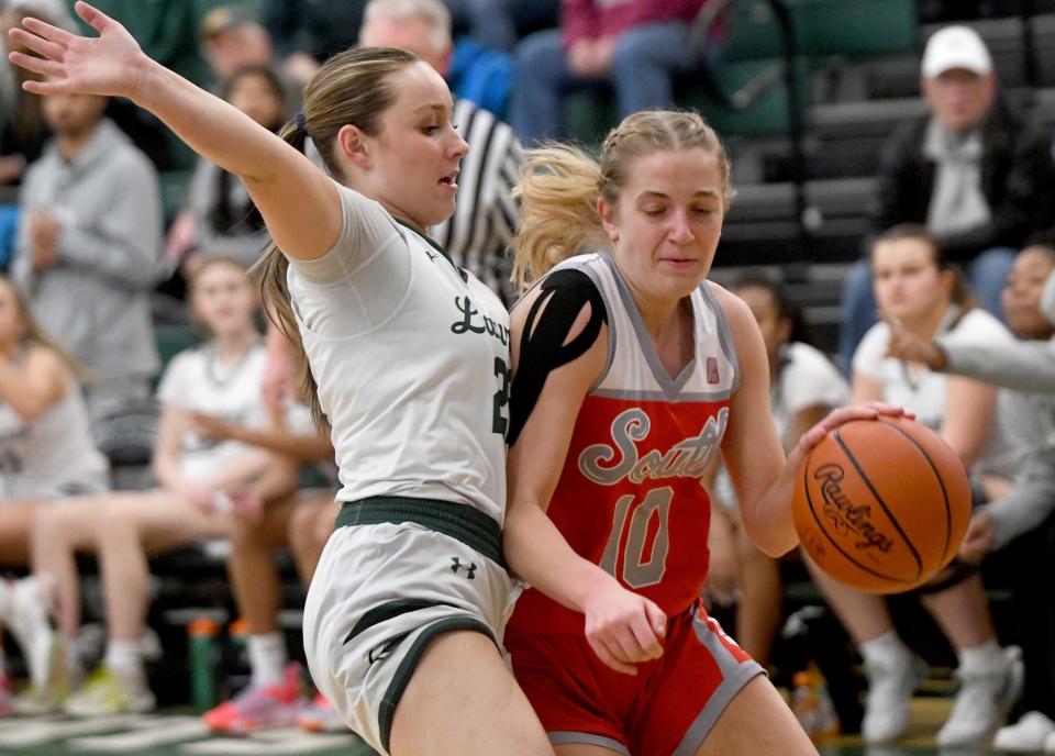 Canton South's Sydney Comer attempts to make her way past Laurel defender Jordyn Meyer in the first quarter of OHSAA Division II District Semifinals at Nordonia High School. Wednesday, February 28, 2024.