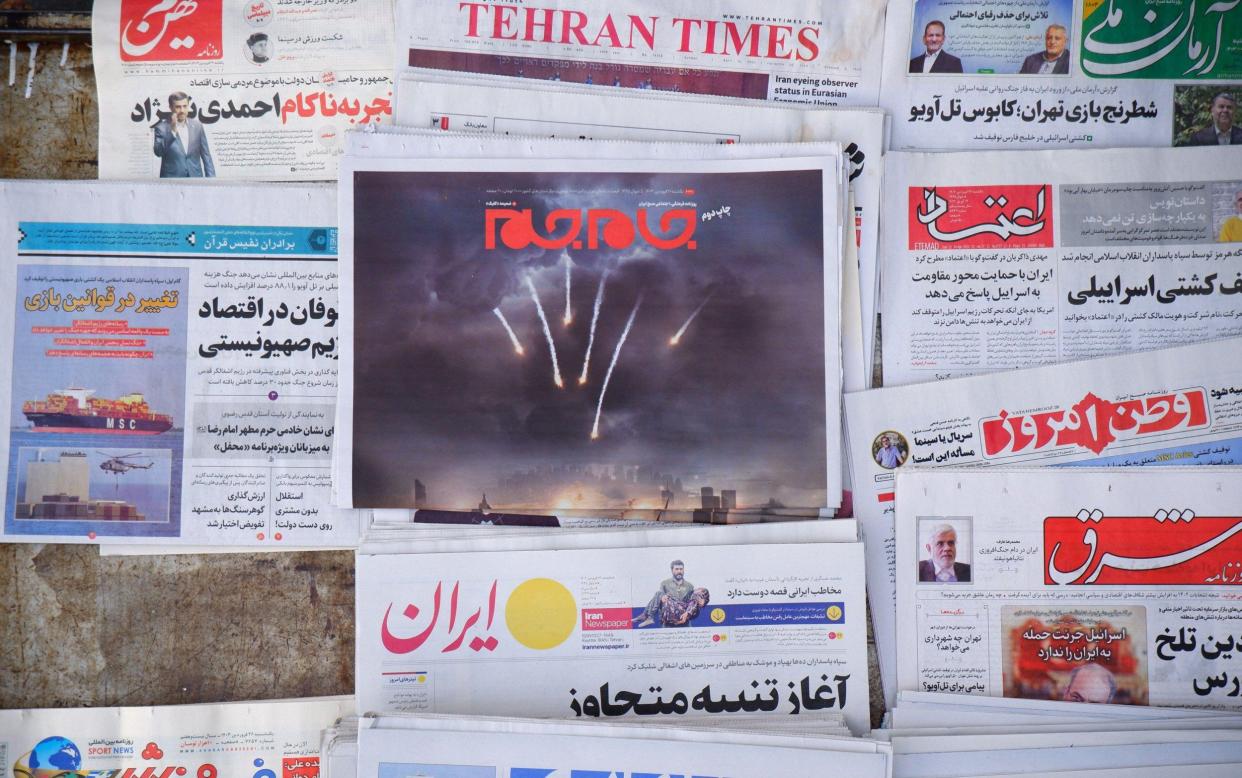 A newspaper featuring an illustrated image of the Iranian surface-to-surface missiles on its front page in downtown Tehran