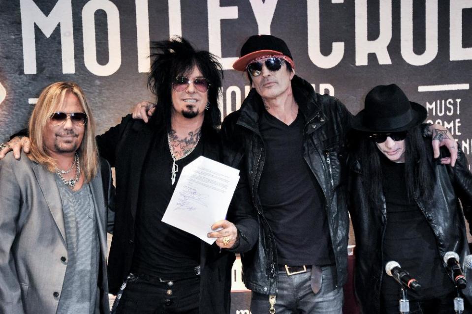 From left, Vince Neil, Nikki Sixx, Tommy Lee, and Mick Mars attend the Motley Crue Press Conference, Tuesday, Jan. 28, 2014, in Los Angeles. (Photo by Richard Shotwell/Invision/AP)