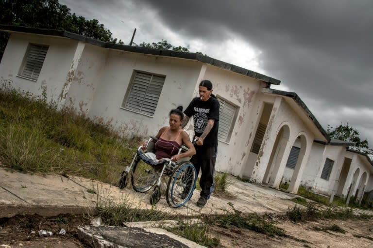 Gerson Govea (R) and his wife Yoandra Cardoso at their home, a former sanatorium for HIV patients, in Pinar del Rio province, Cuba. Like many young punks, Govea saw himself as a misfit. But few embraced the role as self-destructively as this Cuban rocker: he deliberately infected himself with HIV