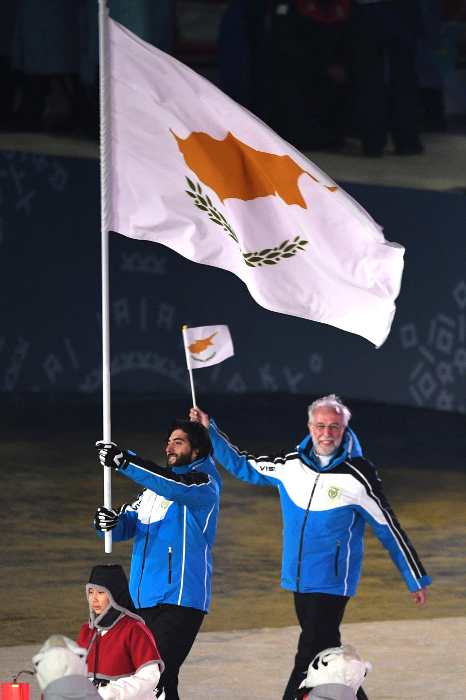 <p>Cyprus flagbearer Dinos Lefkaritis leads the delegation parade during the opening ceremony of the Pyeongchang 2018 Winter Olympic Games at the Pyeongchang Stadium on February 9, 2018. (Photo by ROBERTO SCHMIDT/AFP/Getty Images) </p>