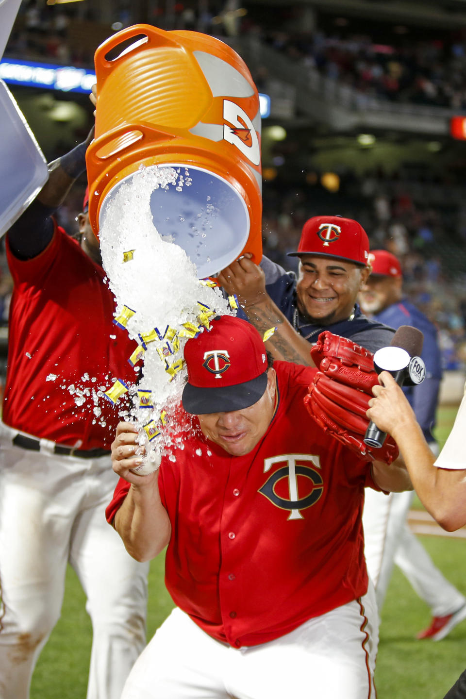 Minnesota Twins starting pitcher Bartolo Colon is doused by teammates after throwing a complete baseball game against the Rangers. (AP)