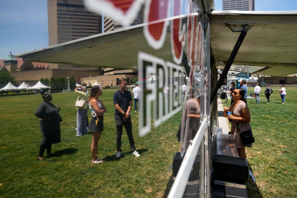 Cricel Gutierrez orders lunch from Mya's Fried Chicken in the food truck food court at the Columbus Commons.