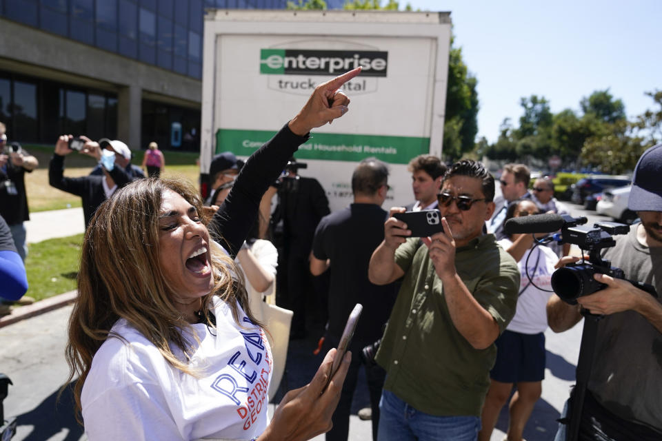 Imelda Hernandez, left, chants as a truck full of petitions to recall Los Angeles County District Attorney George Gascon arrives outside the Los Angeles County Registrar of Voters on Wednesday, July 6, 2022, in Norwalk, Calif. (AP Photo/Ashley Landis)