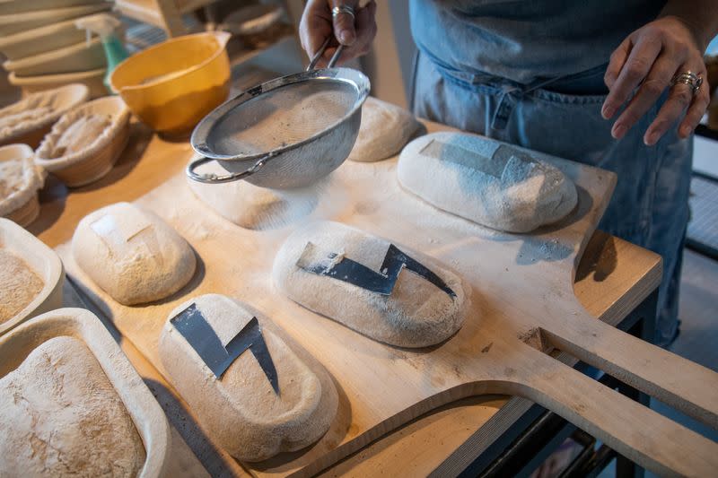 A baker prepares a bread with a bolt sign as a ubiquitous symbol of the protests sweeping across Poland