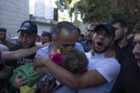 Palestinian Hussein al-Tamimi carries the body of his 2 1/2 year old nephew Mohammed al-Tamimi upon his arrival at the Palestine Medical Complex, in the West Bank city of Ramallah, Monday, June 5, 2023. The Palestinian toddler who was shot by Israeli troops in the occupied West Bank last week died of his wounds on Monday, Israeli hospital officials said. (AP Photo/Nasser Nasser)