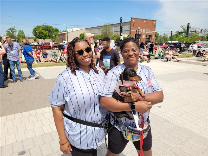 Shermil Hunt, left, and Arica Brison of Jacksonville, Ark. watch the solar eclipse with a canine friend on Monday, April 8, 2024, in Little Rock, Ark.