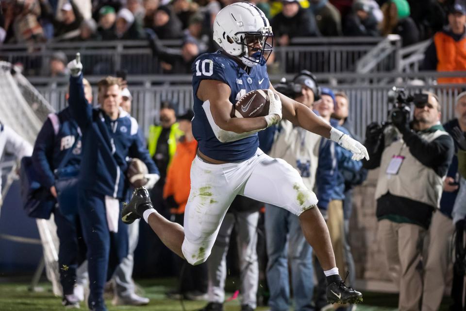 Penn State running back Nick Singleton (10) leaps into the end zone to score a 12-yard rushing touchdown in the fourth quarter against <a class="link " href="https://sports.yahoo.com/ncaaf/teams/michigan-st/" data-i13n="sec:content-canvas;subsec:anchor_text;elm:context_link" data-ylk="slk:Michigan State;sec:content-canvas;subsec:anchor_text;elm:context_link;itc:0">Michigan State</a> at Beaver Stadium on Saturday, Nov. 26, 2022, in State <a class="link " href="https://sports.yahoo.com/ncaaf/players/341504" data-i13n="sec:content-canvas;subsec:anchor_text;elm:context_link" data-ylk="slk:College;sec:content-canvas;subsec:anchor_text;elm:context_link;itc:0">College</a>. The Nittany Lions won, 35-16.