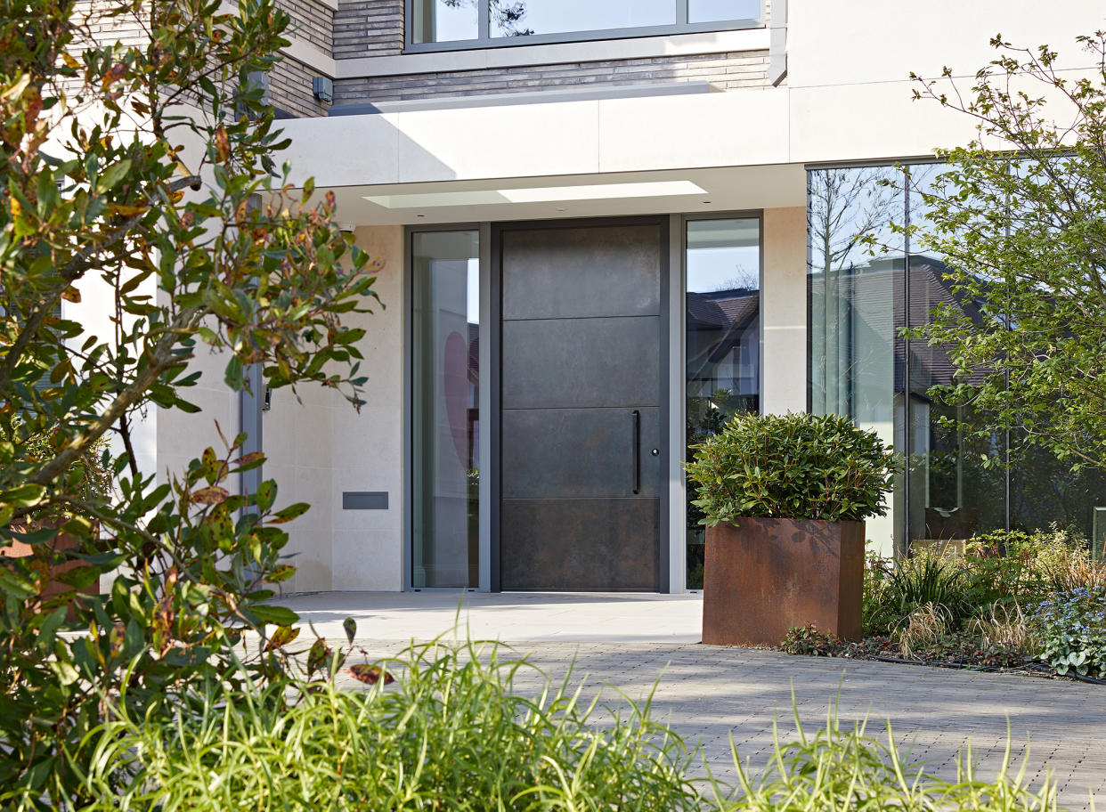 Black front door with glass windows eitherside