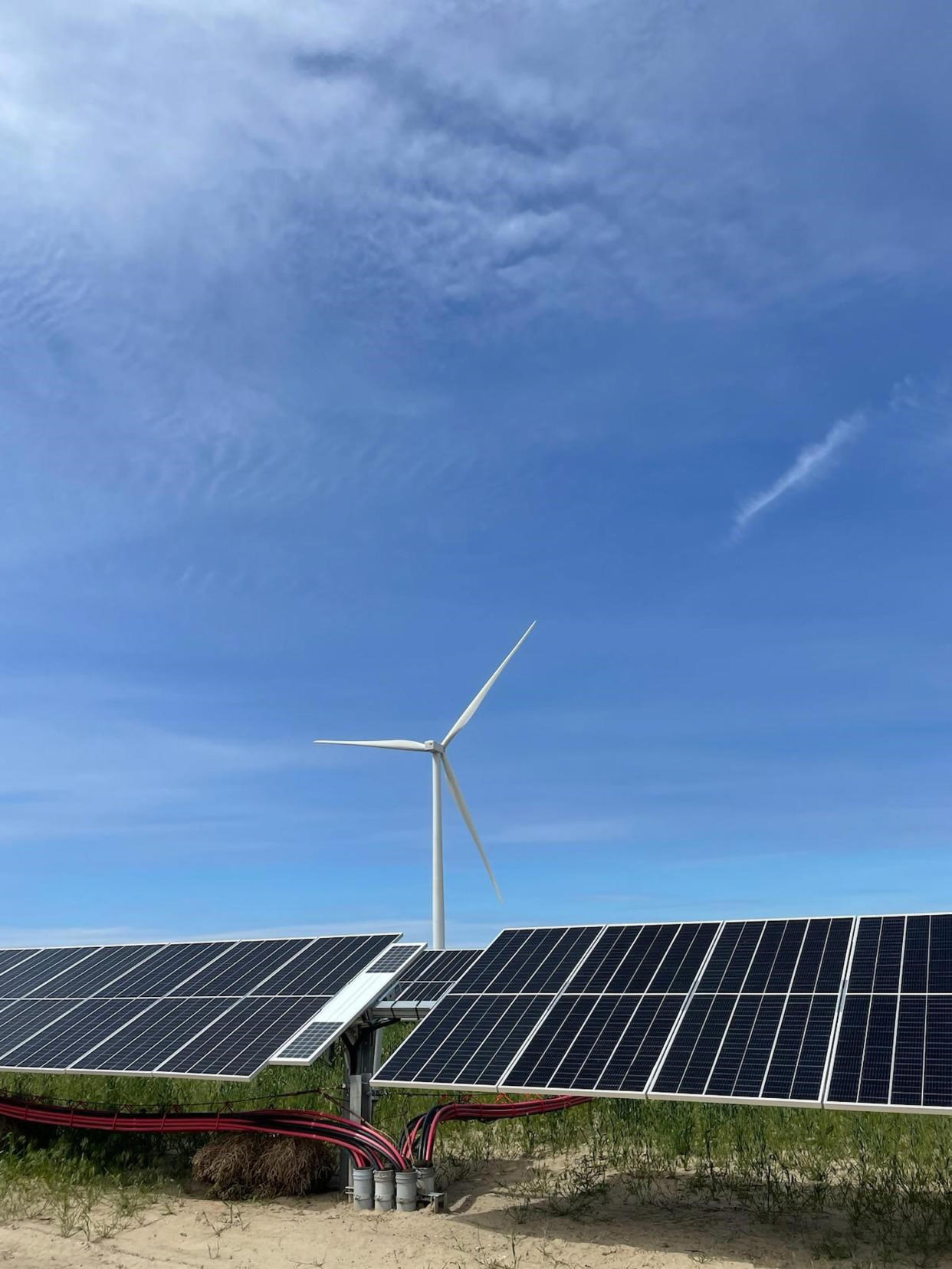 In this image provided by Portland General Electric, windmills and solar panels line a renewable energy facility in Lexington, Ore., on this May 24, 2022. The facility combines solar power, wind power and massive batteries to store the energy generated there. The Wheatridge Renewable Energy Facilities was commissioned Wednesday, Sept. 28, 2022, and is the first utility-scale plant of its kind in North America. Clean energy experts say the project, which can power 100,000 homes, addresses some key challenges facing the industry as the U.S. transitions away from fossil fuels. (Sarah Hamaker/Portland General Electric via AP)