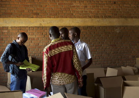 Officials of Burundi's National Electoral Commission take stock of electoral material for the upcoming parliamentary elections at a warehouse in the neighbourhood of Nyakabiga near the capital Bujumbura, June 28, 2015. REUTERS/Paulo Nunes dos Santos