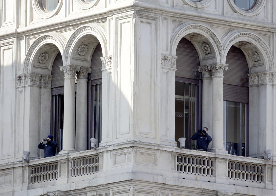 Security officers follow Pope Francis with their binoculars from a nearby building as he arrives at Milan’s Duomo Cathedral to meet members of the Catholic Church, as part of his one-day pastoral visit to Monza and Milan, Italy’s second-largest city, Saturday, March 25, 2017. The pontiff will offer a blessing at the Gothic-era Duomo cathedral. (AP Photo/Luca Bruno)