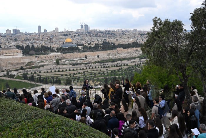 Christians walk in Palm Sunday procession in Jerusalem