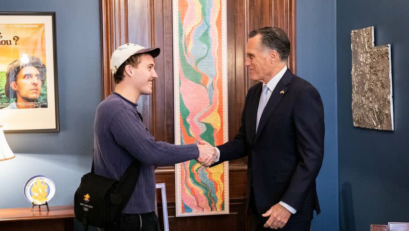 Jack Rutter, known by stage name “Ritt Momney,” shakes hands with Mitt Romney in Washington, D.C., on March 23, 2022.