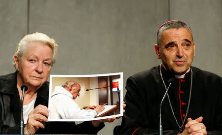 Roselyne Hamel (L) sister of Father Jacques Hamel holds a picture next to Archbishop of Rouen Dominique Lebrun during a media conference at the Vatican, September 14, 2016. REUTERS/Stefano Rellandini