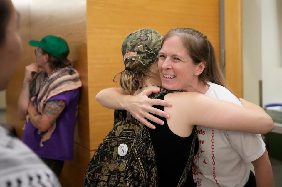 Lisa Faizenbaker, right, hugs Haleigh Bond after Travis County Attorney Delia Garza announced Wednesday that charges have been dropped against them and the rest of the pro-Palestinian protesters who were arrested for criminal trespass April 29 at the University of Texas.