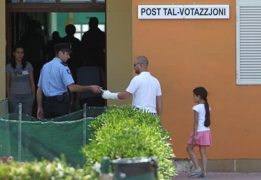 Voters go to cast their vote in Valetta, Malta, on May 28, in a referendum on divorce. Overwhelmingly Catholic Malta has voted to legalise divorce, Prime Minister Lawrence Gonzi has announced, after votes were counted following a non-binding referendum the day before