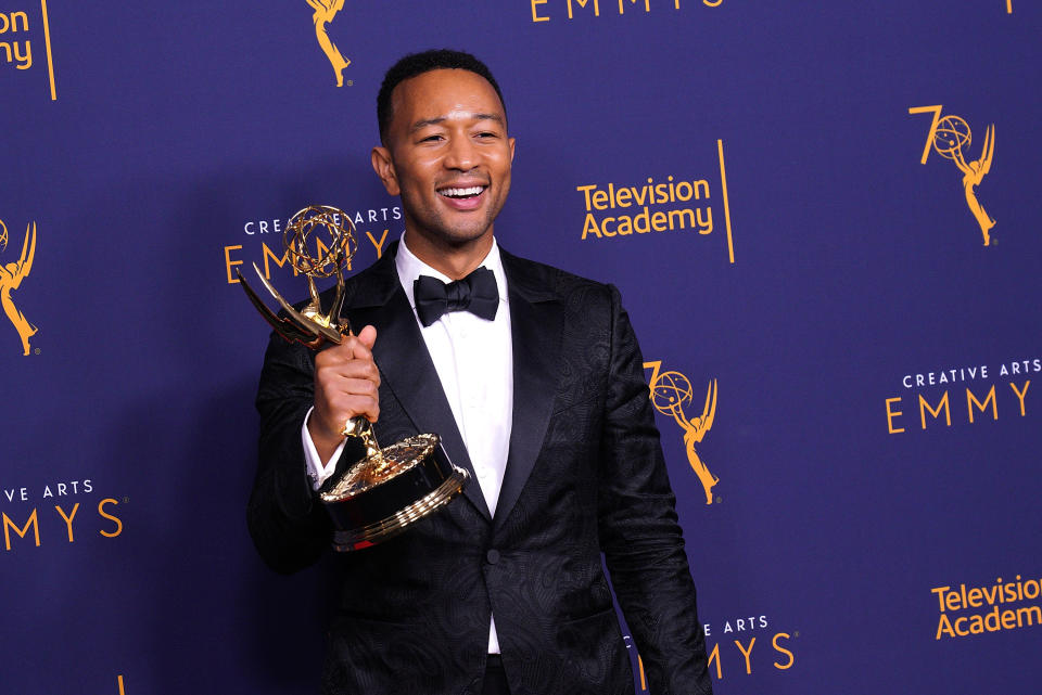 John Legend holding his Tony Award