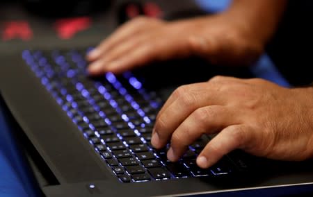 FILE PHOTO: A man types into a keyboard during the Def Con hacker convention in Las Vegas