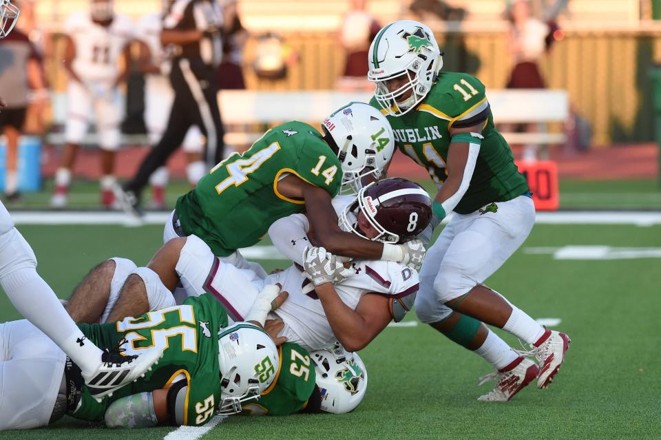 Dublin's Dalan Rasberry (14), Javier Parra (25) and Christian Ramirez (11) combine to bring down De Leon's Trey Lopez (8) at Bob and Norma Cervetto Field on Friday, Aug. 28, 2020.