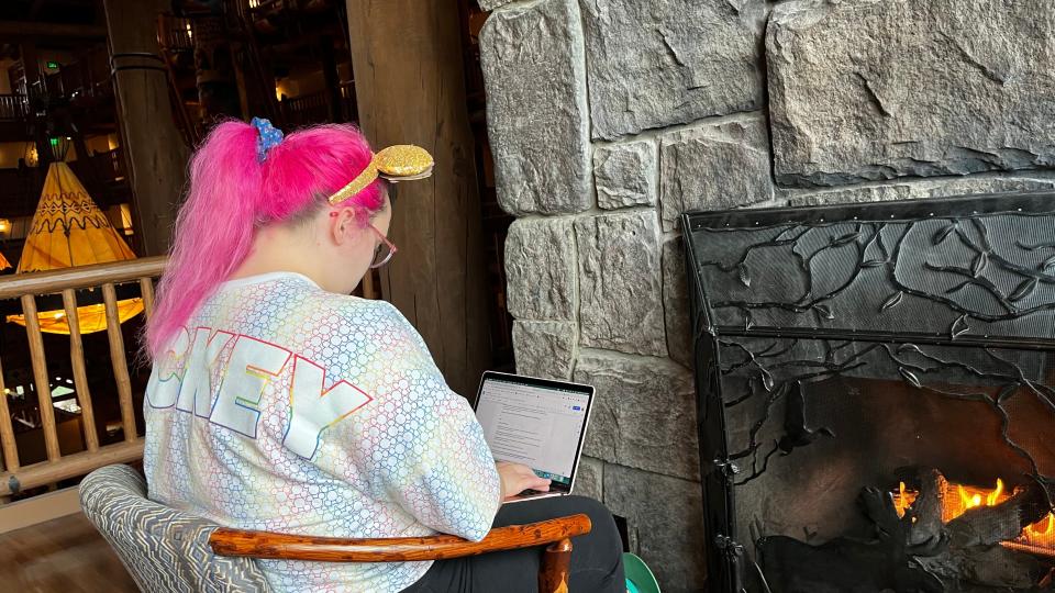 writer in front of fireplace in disney lodge during huricane ian