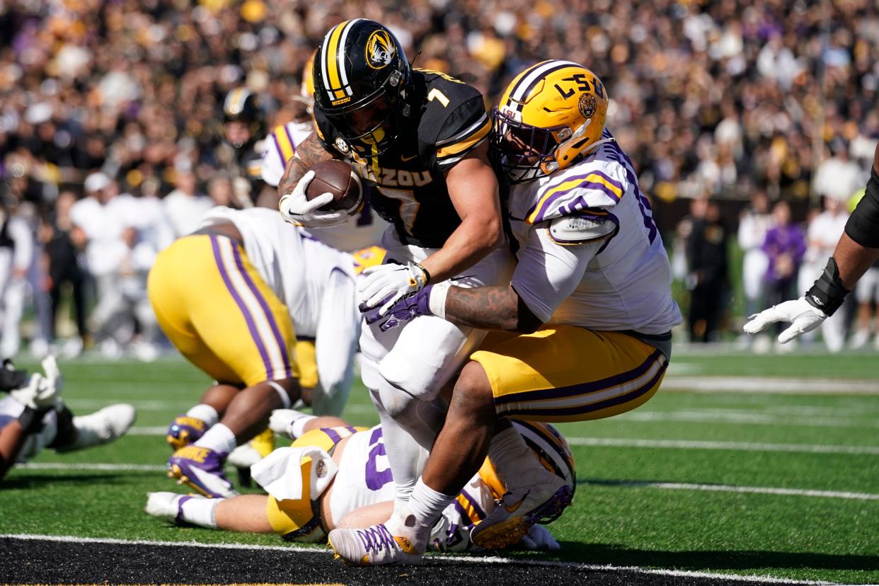 LSU's Mekhi Wingo tackles Missouri running back Cody Schrader as he scores a touchdown in the second half Oct. 7, 2023 in Columbia, Missouri.