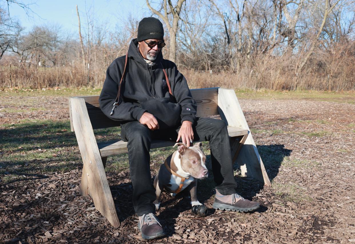 Gervis Myles, a former Wisconsin conservation warden who left after years of issues within the conservation warden program, at Estabrook Dog Park with his dog The Mighty Mikey, on Dec 12, 2023.