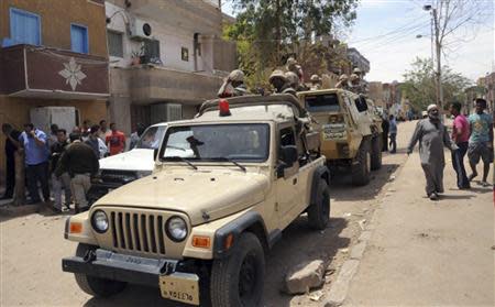 Members of the Egyptian army take position in attempt to stop clashes between members of the Nubian and the Arab Beni Helal clans in the southern city of Aswan, south of Cairo April 6, 2014. REUTERS/Al Youm Al Saabi Newspaper