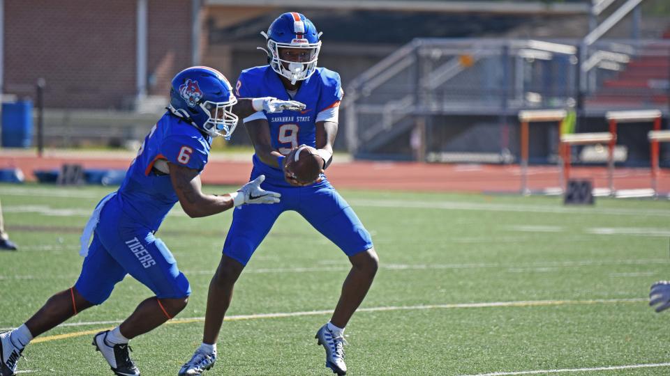 Savannah State quarterback Jadon Adams, hands off to a teammate during SSU's spring scrimmage Saturday.