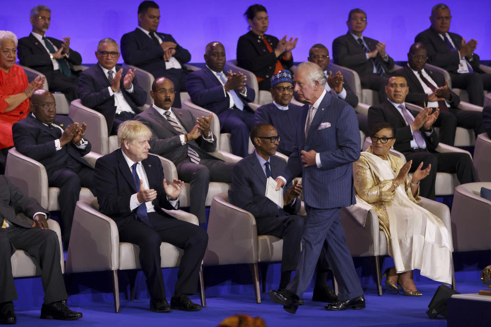 Dignitaries and delegates including Britain's Prime Minister Boris Johnson applaud as Britain's Prince Charles walks on stage during the opening ceremony of the Commonwealth Heads of Government Meeting (CHOGM) on Friday, June 24, 2022 in Kigali, Rwanda. Leaders of Commonwealth nations are meeting in Rwanda Friday in a summit that promises to tackle climate change, tropical diseases and other challenges deepened by the COVID-19 pandemic. (Dan Kitwood/Pool Photo via AP)